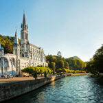"Cathedral of Lourdes, FranceBelow the Basilique behind the trees the Grotte de MassabilleLourdes is a small market town lying in the foothills of the Pyrenees, famous for the Marian apparitions of Our Lady of Lourdes that are reported to have occurred in 1858 to Bernadette Soubirous."